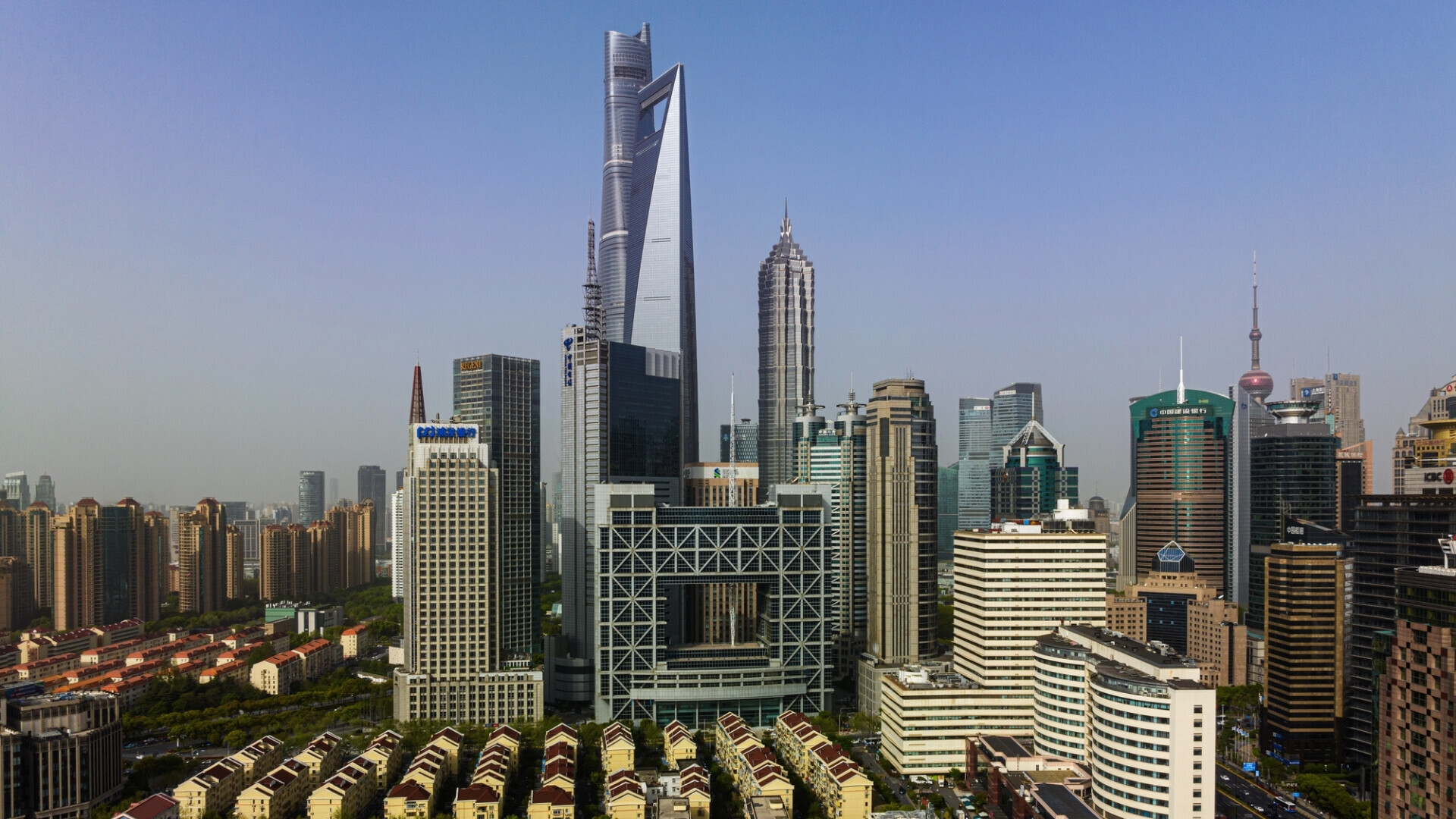 Vista della zona finanziaria moderna di Shanghai con grattacieli e sede della borsa in primo piano.