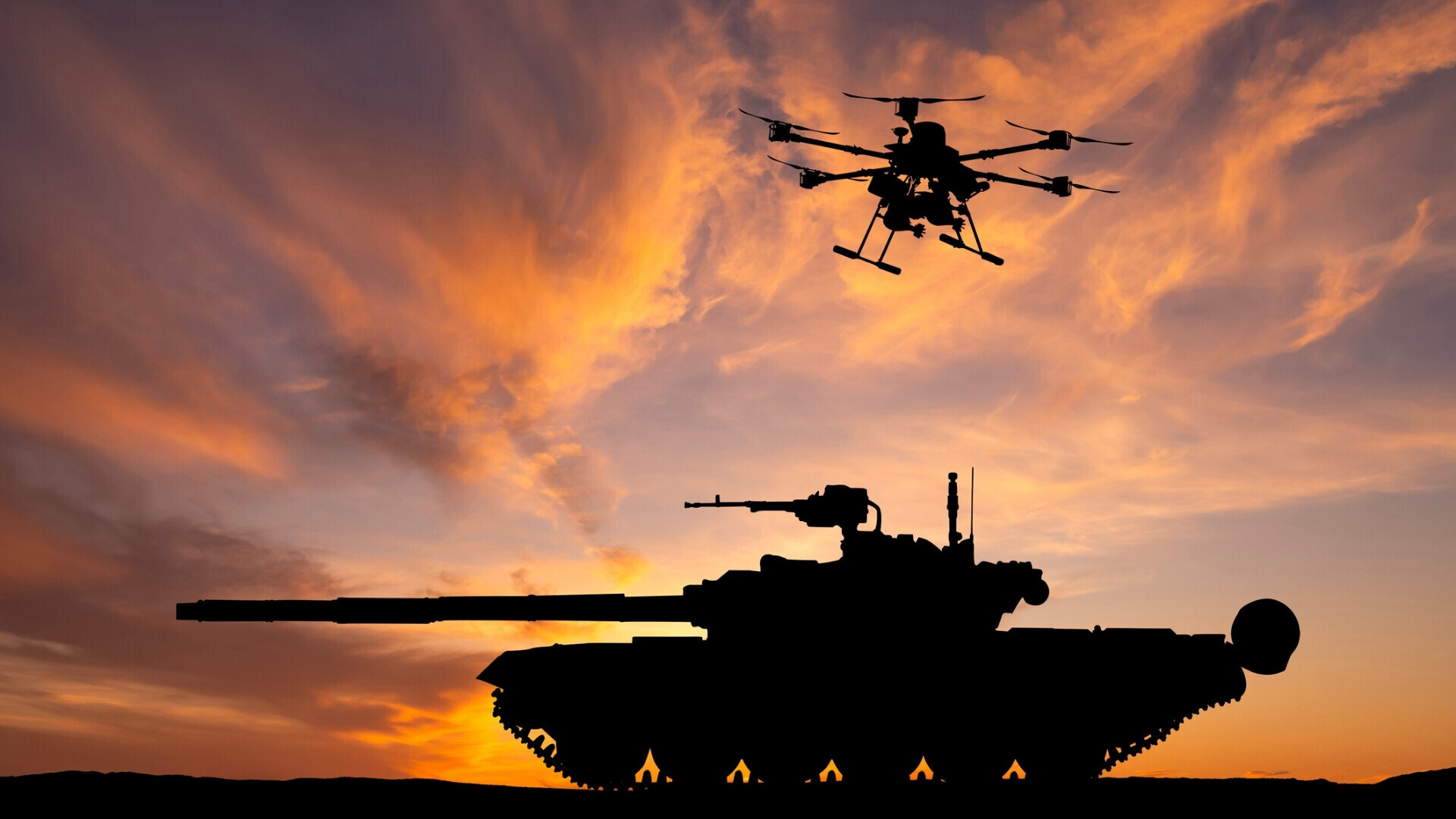 Drone da combattimento sorvola un carro armato, pronto a sganciare bombe in un contesto bellico simulato o reale.