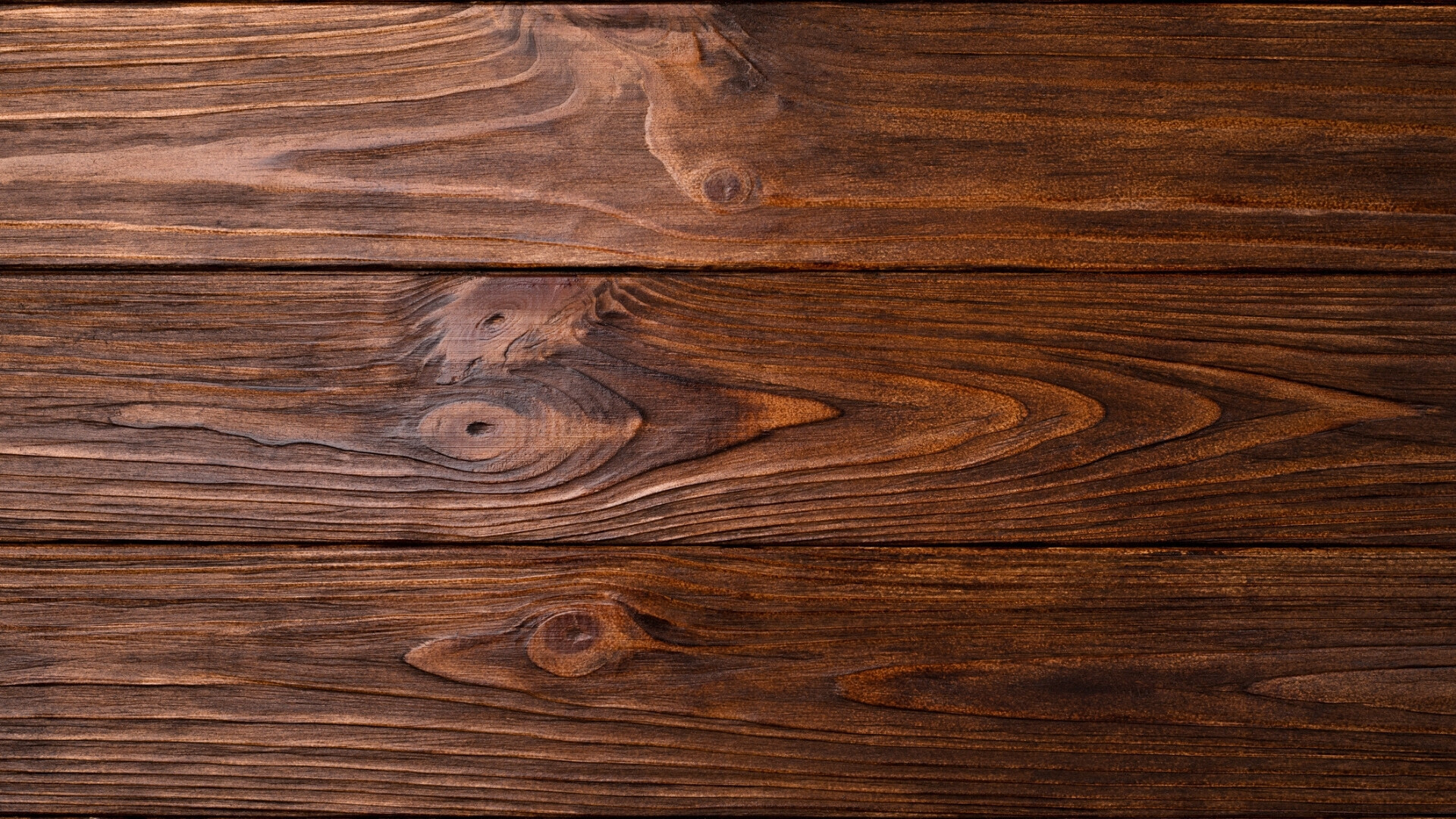 Foto di sfondo in legno vuoto, altamente texturizzato, scuro e rustico, con spazio per testo.